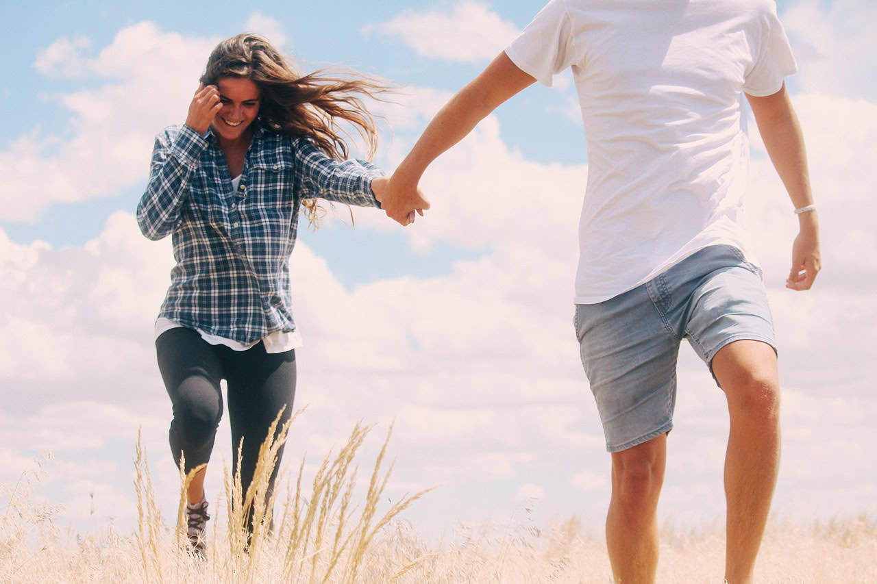 man holding woman's hand