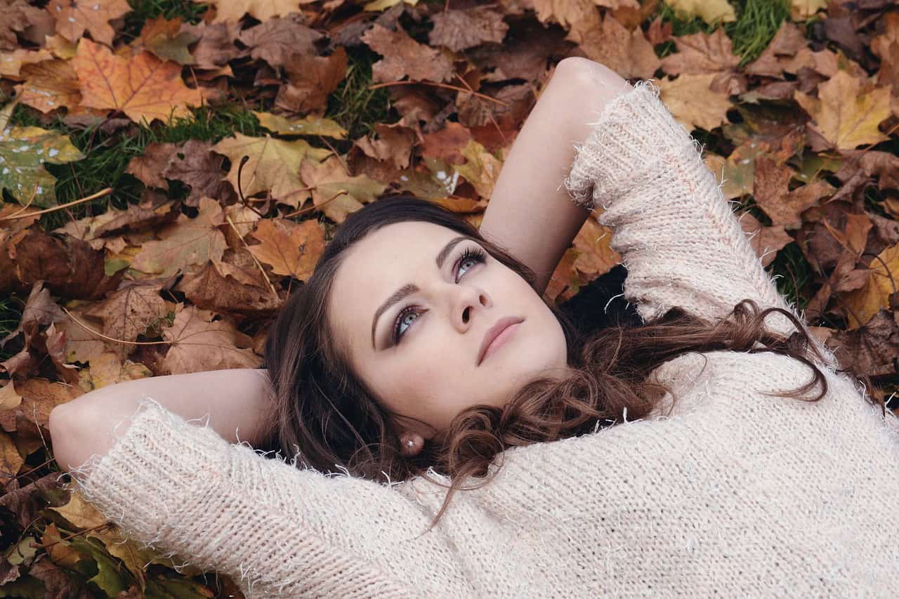 woman lying in a pile of leaves